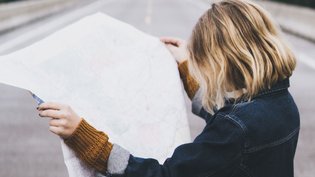 Female students on the road reading a map